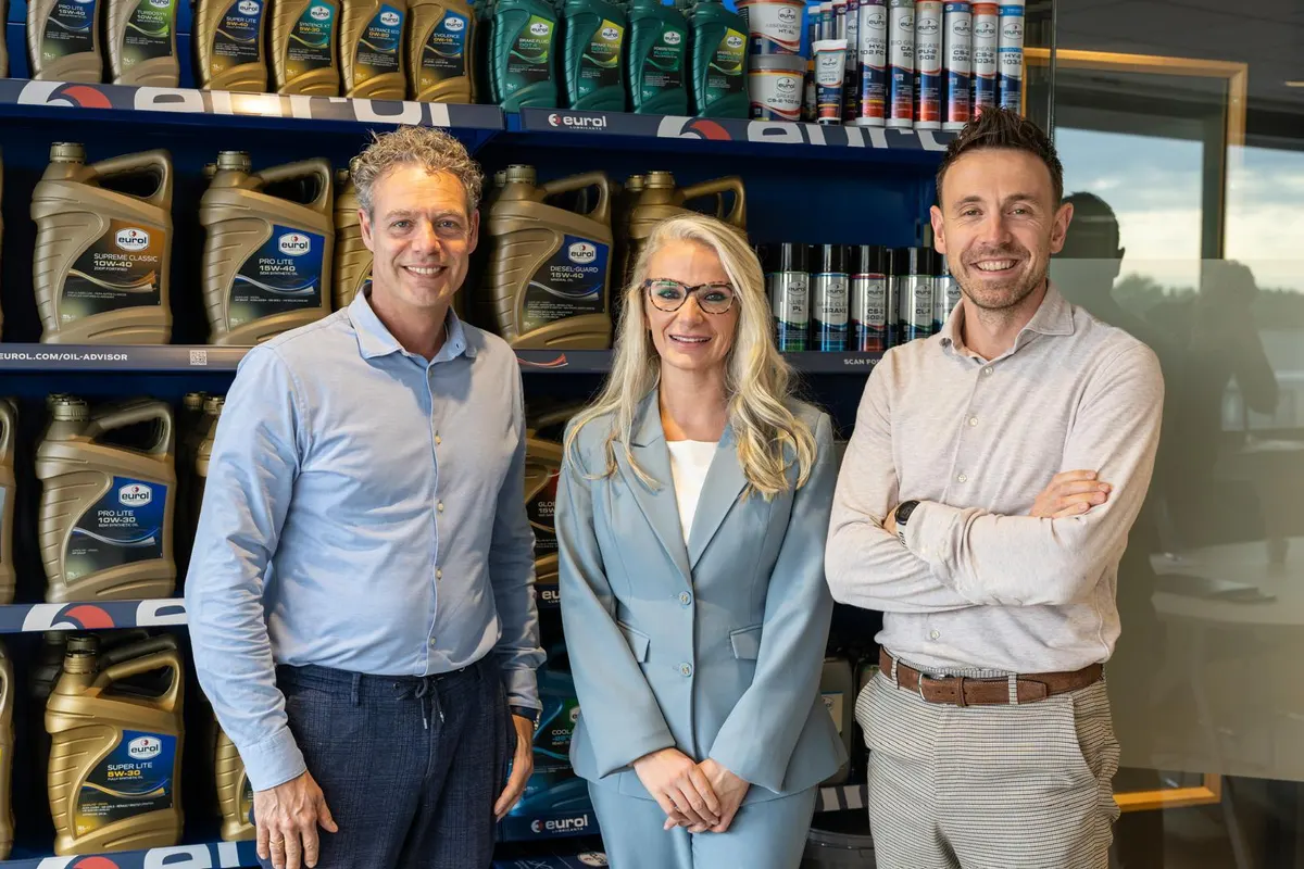 Three professionals in front of a Eurol lubricants display, accompanying the Account Manager International - African Market vacancy